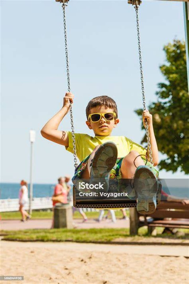 Boy Playing Swinging by Swingset. Stock Image Image of height