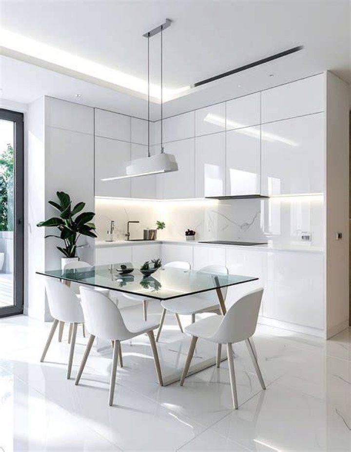 Minimalist staged kitchen dining living room in open concept home with large windows.